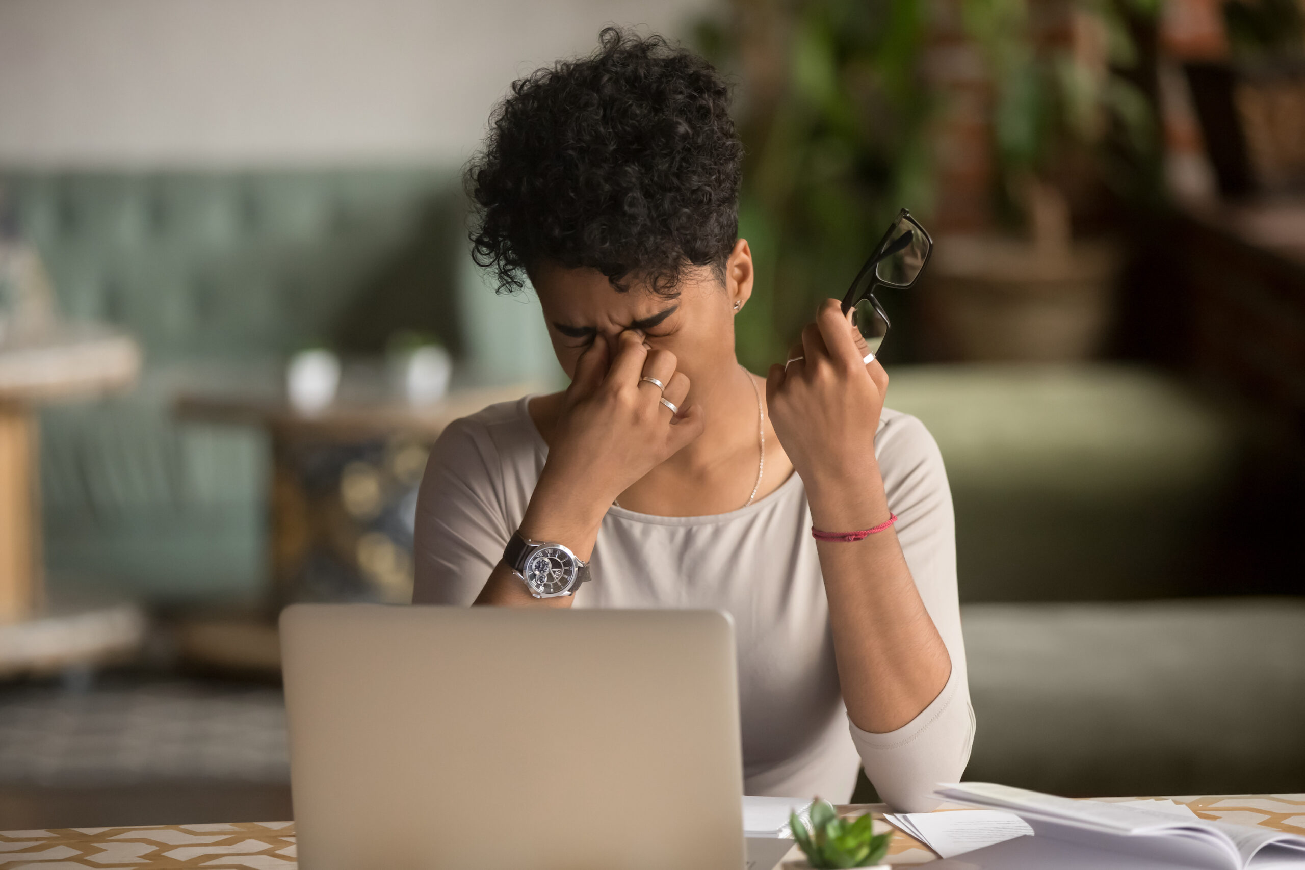 Woman feeling eye strain fatigue after computer work